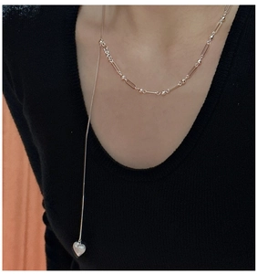 Detail of S925 sterling silver heart pendant necklace with y-shaped long drop chain