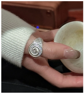 Macro detail of S925 sterling silver spiral ring featuring a square zircon on hand