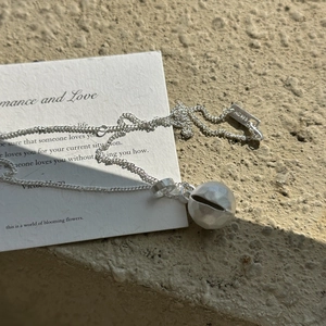Minimalist S925 sterling silver necklace with a matte textured sphere pendant on stone