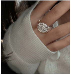 Macro view of retro S925 silver ring with zircon and spiral texture on hand