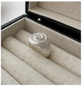 Macro shot of S925 silver ring featuring spiral design with square zircon in a jewelry box