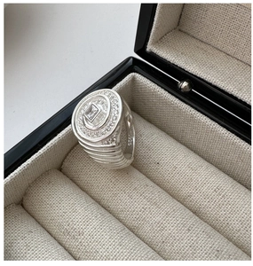 Macro detail of S925 silver cocktail ring with spiral zircon stones in jewelry box
