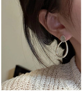 Close-up of S925 sterling silver labradorite earrings on model with oval drop design