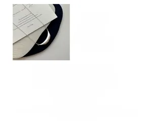 Macro detail of S925 sterling silver smile necklace with brushed texture and plating
