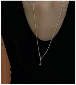 Close-up of S925 silver wheat chain necklace featuring a single zircon pendant