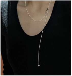 Detail of S925 sterling silver Chopin Y-chain necklace on a black turtleneck sweater