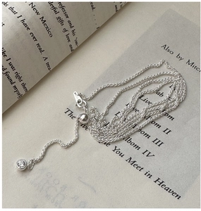 Macro detail of S925 sterling silver Chopin chain with a single round zircon pendant