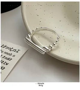 Close-up of S925 sterling silver horizontal bar ring on a ceramic plate detail