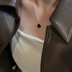 Minimalist S925 silver necklace with a round black onyx pendant on a female model