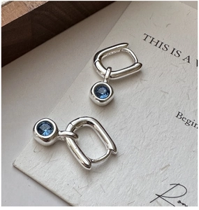 Close-up of S925 sterling silver hoop earrings with round blue zircon crystal drops