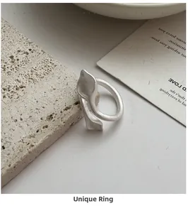 Detail of S925 sterling silver leaf ring with matte brushed finish on textured stone