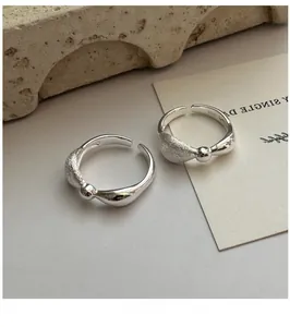 Detailed close-up of S925 sterling silver bow rings with textured and polished finish