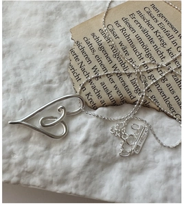 Macro view of S925 sterling silver heart necklace with detailed AG925 hallmark