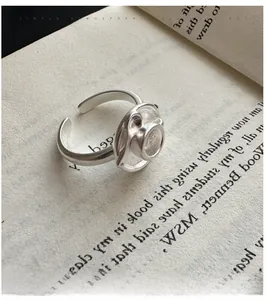 Macro shot of S925 sterling silver ring with unique coffee cup design on book pages