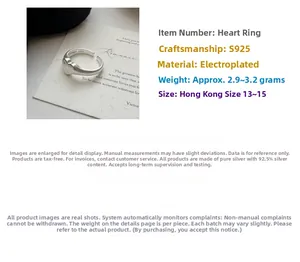 Macro shot of S925 sterling silver matte heart ring showing weight and material details