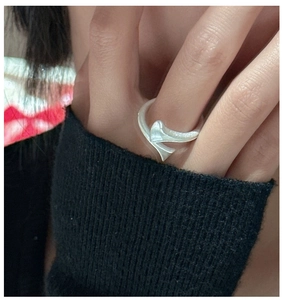 Detail of S925 sterling silver ring with brushed matte finish on a twisted spiral design