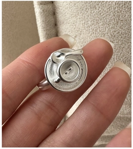 Detail of S925 silver ring featuring a miniature coffee cup with a tiny heart latte art