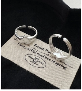 Close-up of S925 sterling silver heart ring with matte finish and hallmark stamp