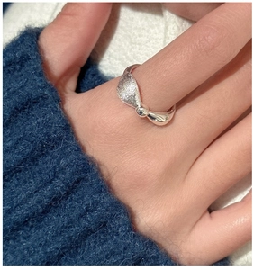 Close-up of S925 silver ring featuring asymmetrical brushed and polished textures on finger