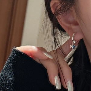 Elegant S925 silver hoop earring with a round dark blue zircon charm worn by a model
