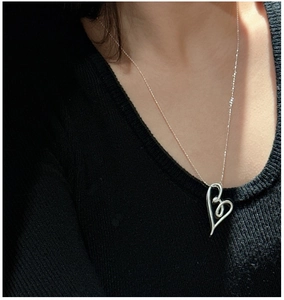 Detailed view of an S925 silver hollow heart-shaped pendant on a fine necklace