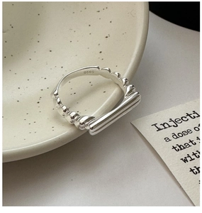 Macro shot of S925 sterling silver ring detail with geometric bar design on ceramic