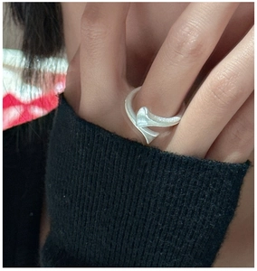 Close-up of minimalist S925 sterling silver matte cross open ring on finger