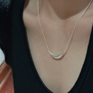 S925 sterling silver smile necklace with a minimalist brushed finish worn by a model