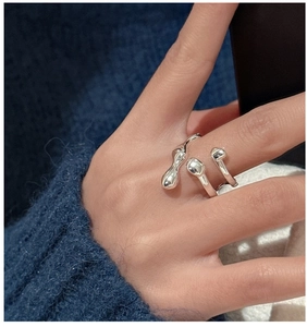 Detailed view of silver liquid metal style ring featuring a unique irregular drop design