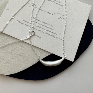 Minimalist S925 sterling silver smile necklace with a matte brushed finish pendant