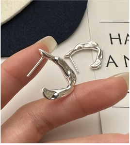 Macro detail of S925 sterling silver irregular molten texture C-shape hook earrings
