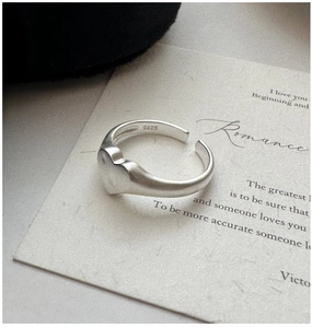 Macro detail of S925 sterling silver matte heart ring with adjustable open band