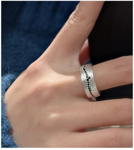 Macro shot of matte S925 sterling silver ring with black zircon stones in wave setting