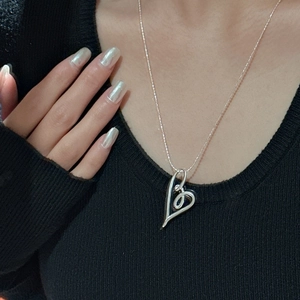 S925 sterling silver heart knot necklace with minimalist hollow design on black knitwear
