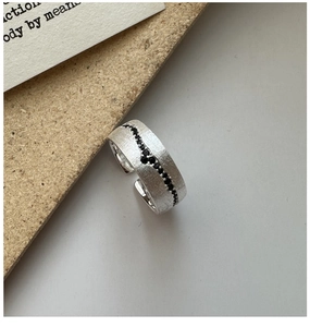 Macro detail of S925 sterling silver ring with brushed finish and black zircon inlay