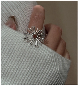 Macro shot of S925 sterling silver firework ring with artistic sunburst radial lines
