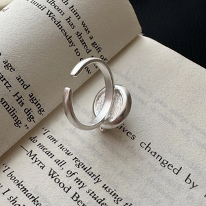 Minimalist S925 sterling silver coffee cup ring with matte texture on vintage book