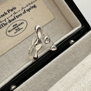 S925 Sterling Silver crossover liquid metal ring with adjustable open design on display