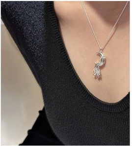 Close-up of S925 silver crescent moon necklace with dangling stars and sparkling cubic zirconia