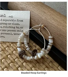 Close-up of bohemian S925 silver beaded hoop earrings with white shells and natural stones
