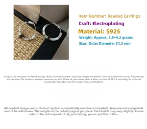 Detailed view of S925 sterling silver hoop earrings with white shell and wooden beads