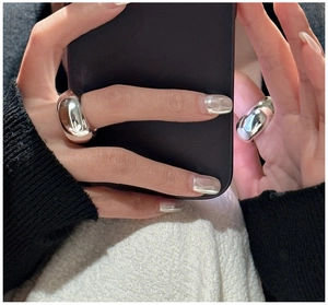 Close-up of minimalist thick S925 silver rings with mirror finish on fingers