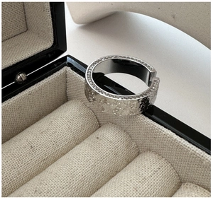 Detailed view of S925 silver wide ring with clover embossing and micro-set zirconia