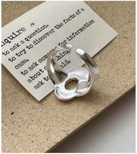 Close-up of S925 sterling silver ring featuring a streamlined design and engraved hallmark