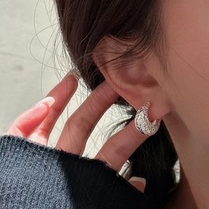S925 sterling silver hoop earrings with textured lava finish worn by a model