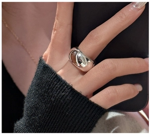 Polished S925 sterling silver wide band ring with a reflective mirror finish on finger