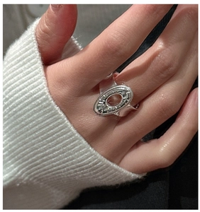 Macro detail of S925 sterling silver ring featuring an oval hollow radial engraved design