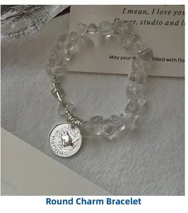 Detailed shot of S925 silver bracelet featuring bird coin charm and white crystal beads