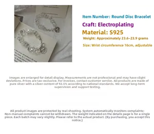 Detail of S925 silver bird tag and clear crystal beads on an elastic minimalist bracelet