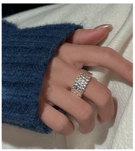 Detail view of a textured S925 sterling silver wide ring with a unique bubbly pattern
